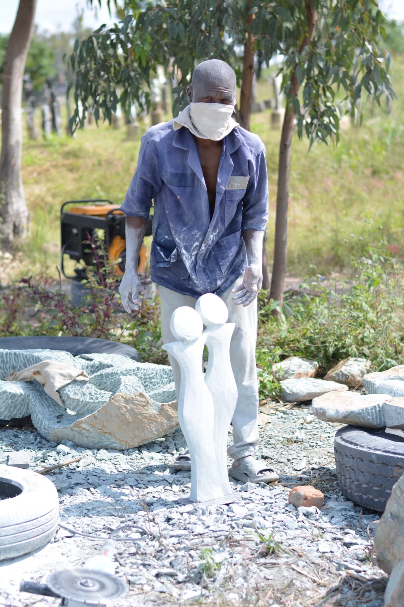 Shona sculpture finishing process — hand carved Zimbabwe stone art waxed and polished by the artist